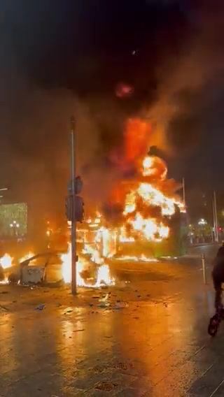 A City Bus and several Police Cars alongside a few Personal Vehicles have been Caught on Fire and Destroyed in Dublin, Ireland tonight during the Riots across the City caused by the Stabbing Attack today